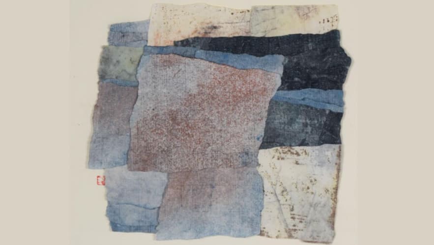 A piece of artwork consisting of multiple overlapping swatches of different colored cloth.