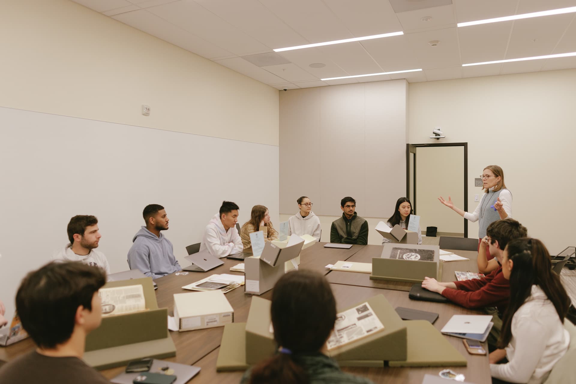 Students and instructor using archival material in Special Collection classroom